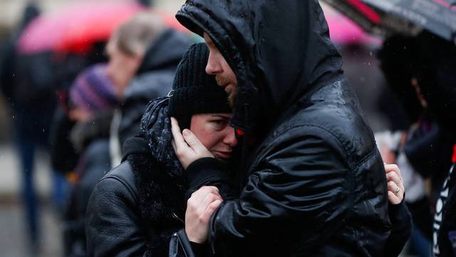 People observe a minute of silence in memory of the victims of the Charles University shooting, in Prague