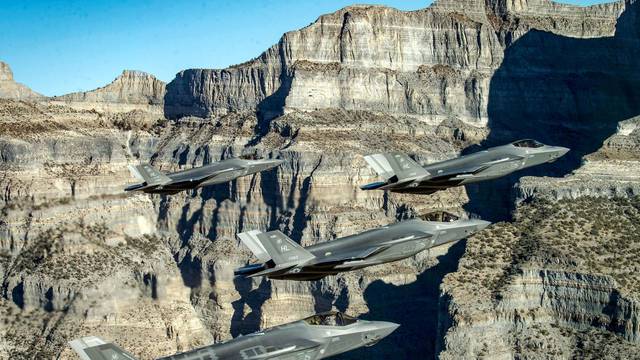 FILE PHOTO: A formation of U.S. Air Force F-35 Lightning II fighter jets perform aerial maneuvers during as part of a combat power exercise
