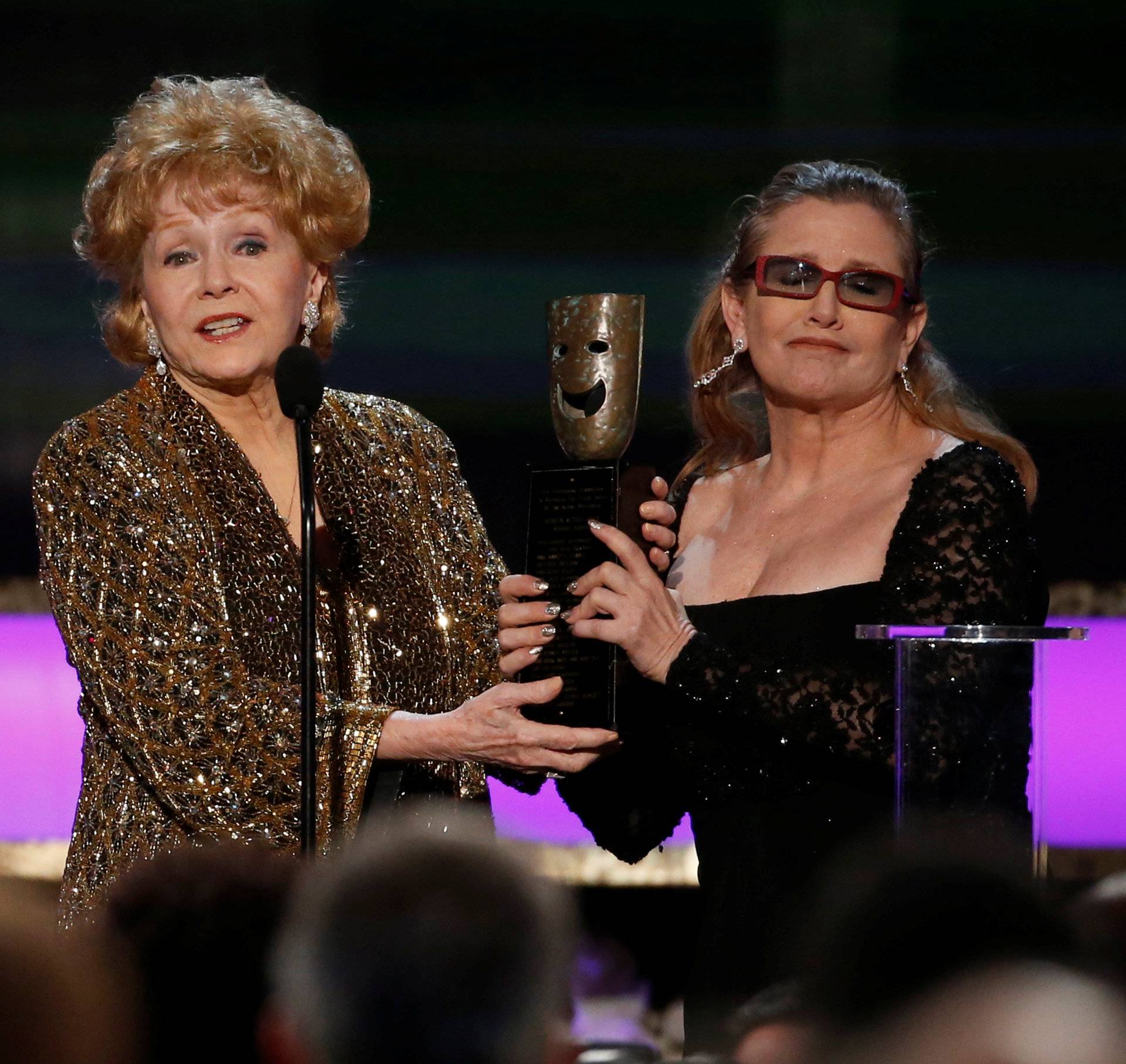 FILE PHOTO: Actress Debbie Reynolds accepts the life achievement award from her daughter actress Carrie Fisher at the 21st annual Screen Actors Guild Awards in Los Angeles