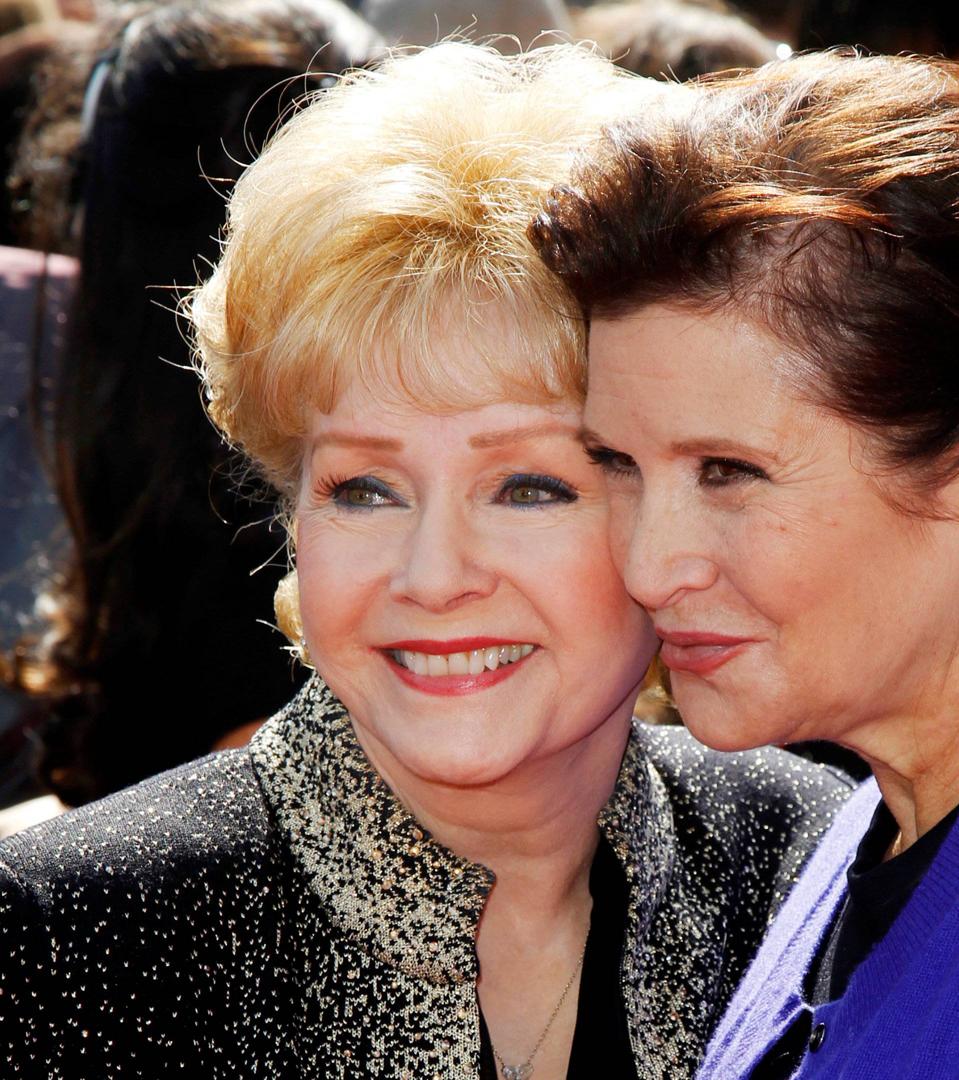 FILE PHOTO: Actress Debbie Reynolds and her daughter Carrie Fisher arrive at the 2011 Primetime Creative Arts Emmy Awards in Los Angeles