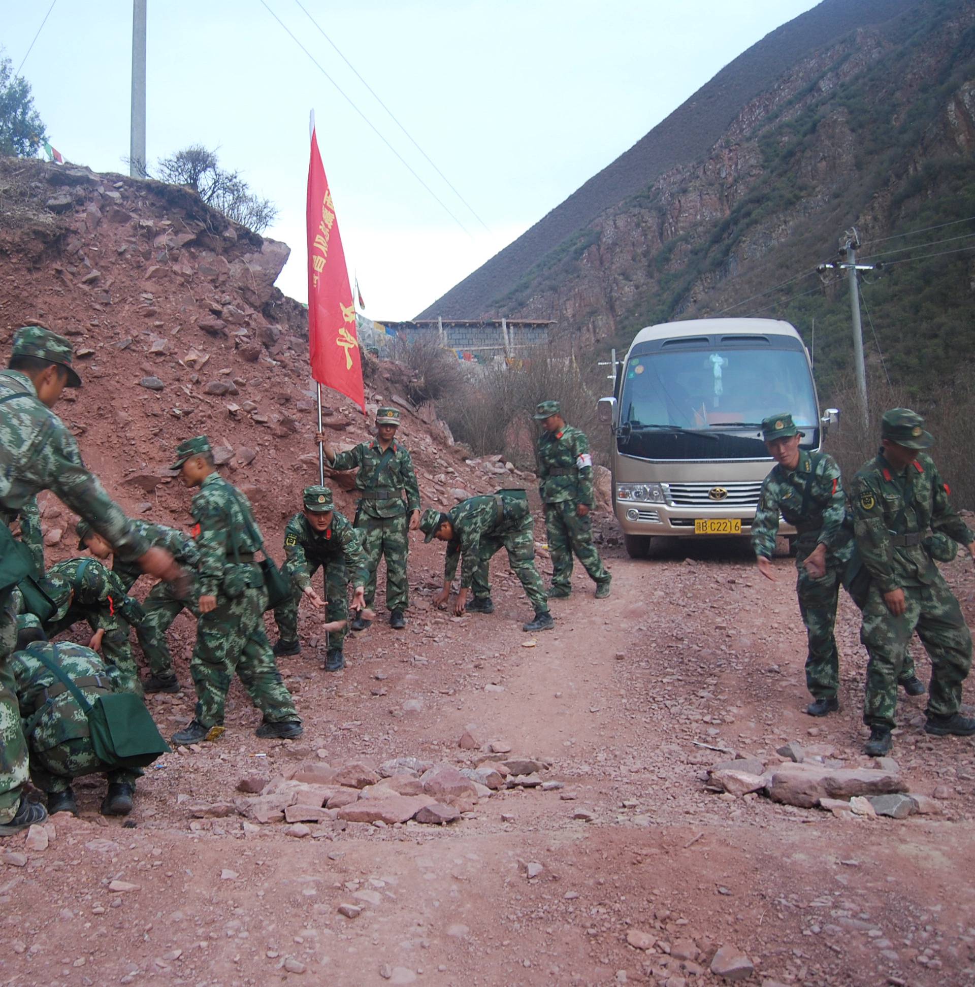 Paramilitary policemen remove rocks after an earthquake injured over 60 people in Chamdo