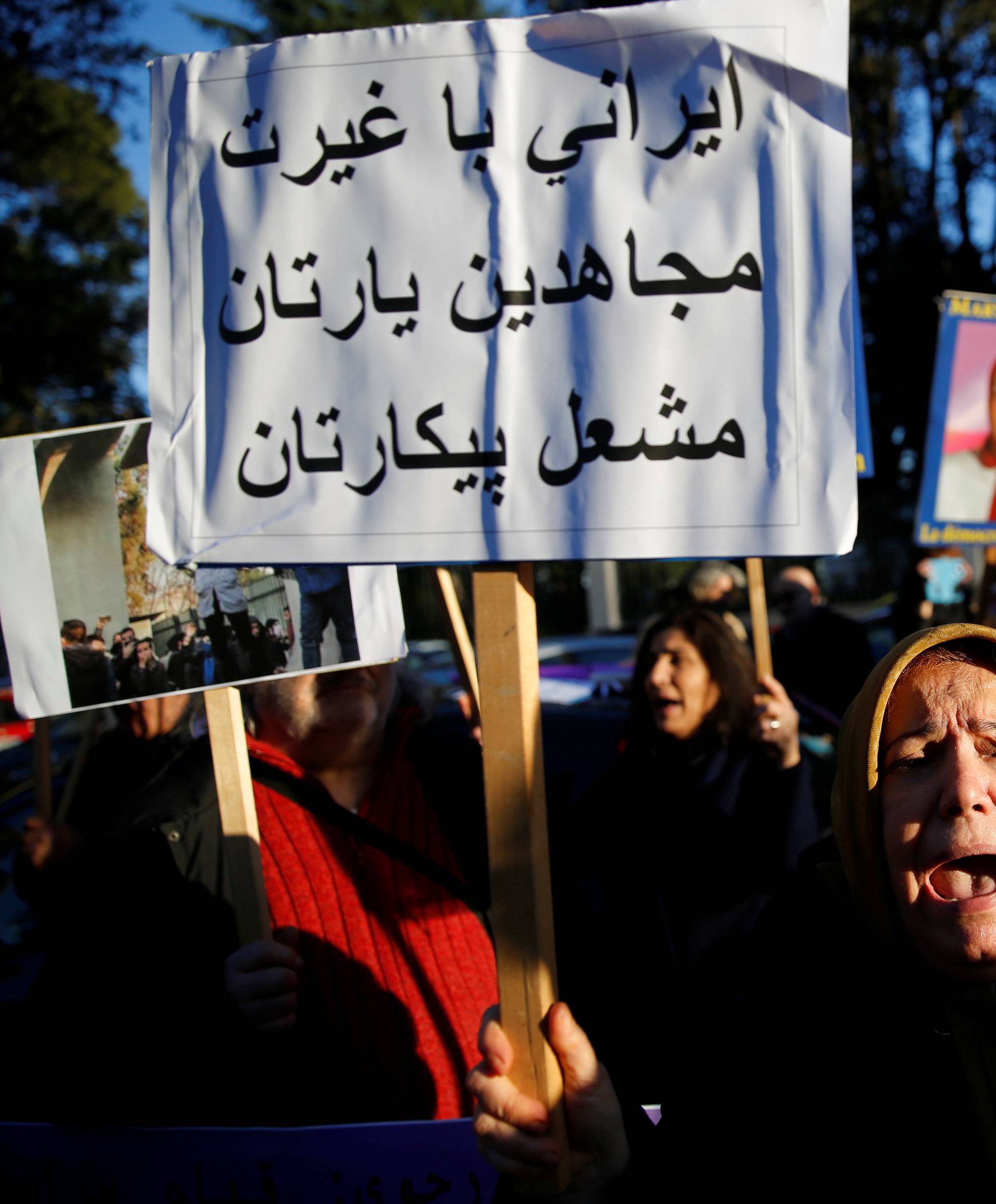 Opponents of Iranian President Hassan Rouhani hold a protest outside the Iranian embassy in Rome