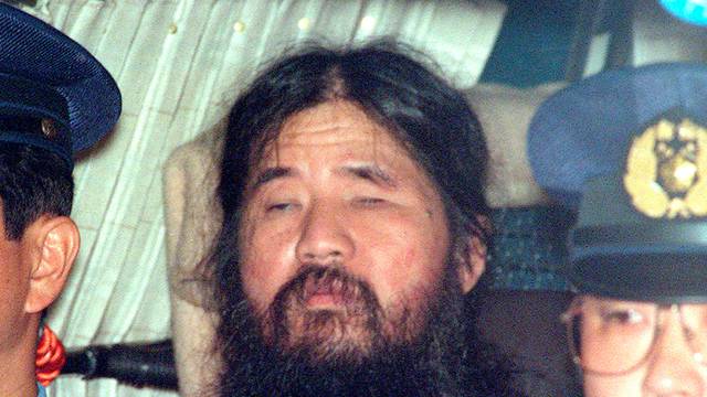 Japanese doomsday cult leader Shoko Asahara sits in a police van following an interrogation in Tokyo