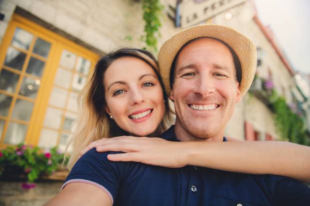 Outdoor lifestyle portrait of young couple in love in old town