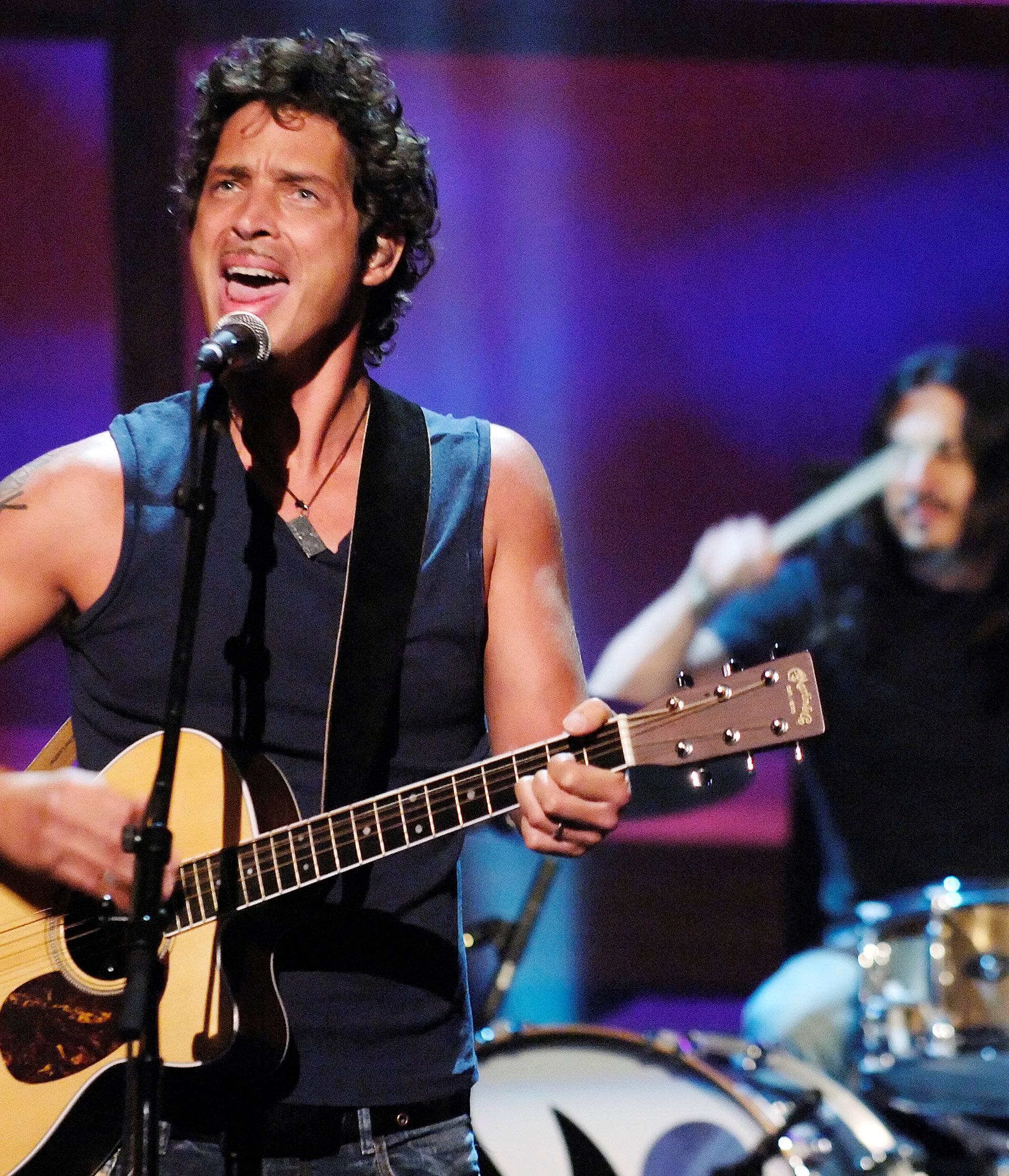 FILE PHOTO: Chris Cornell and Brad Wilk of music group Audioslave perform live during the "ReAct Now: Music & Relief" special at Paramount Studios in Los Angeles