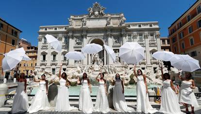 Brides wearing wedding dresses hold a flash mob near Trevi fountain to protest against the postponement of their weddings due to the coronavirus disease (COVID-19) outbreak in Rome
