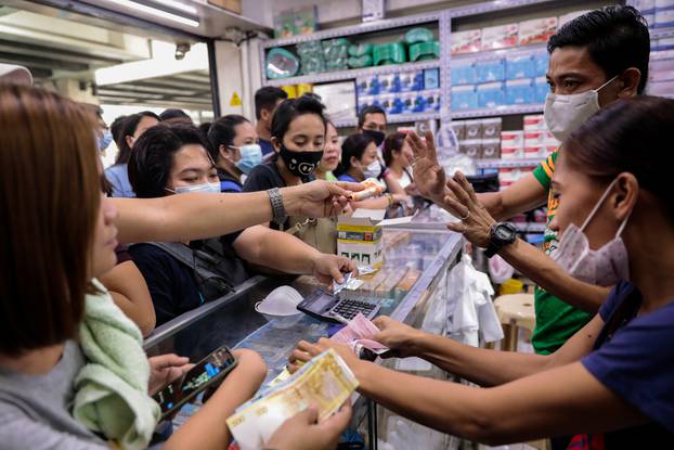 People scramble to buy face masks in a medical supply store a day after Philippine government confirmed first novel coronavirus case