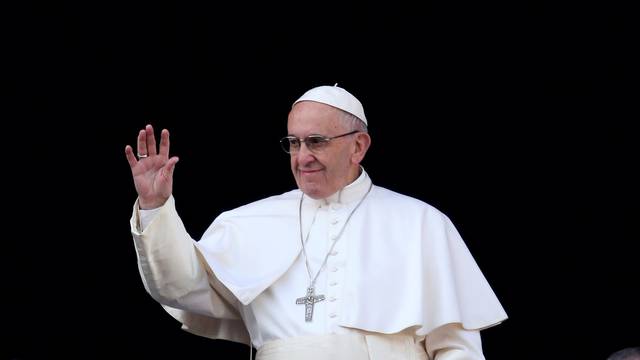 Pope Francis waves as he arrives to leads "Urbi et Orbi" (to the city and the world) message from the balcony overlooking St. Peter's Square at the Vatican