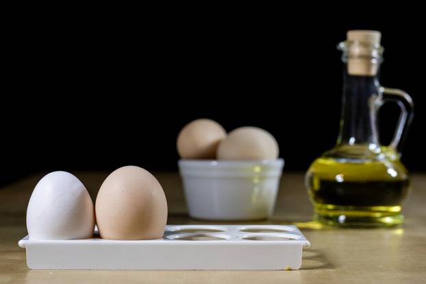 Egg, olive oil, spices on the kitchen table. Wooden table, kitch