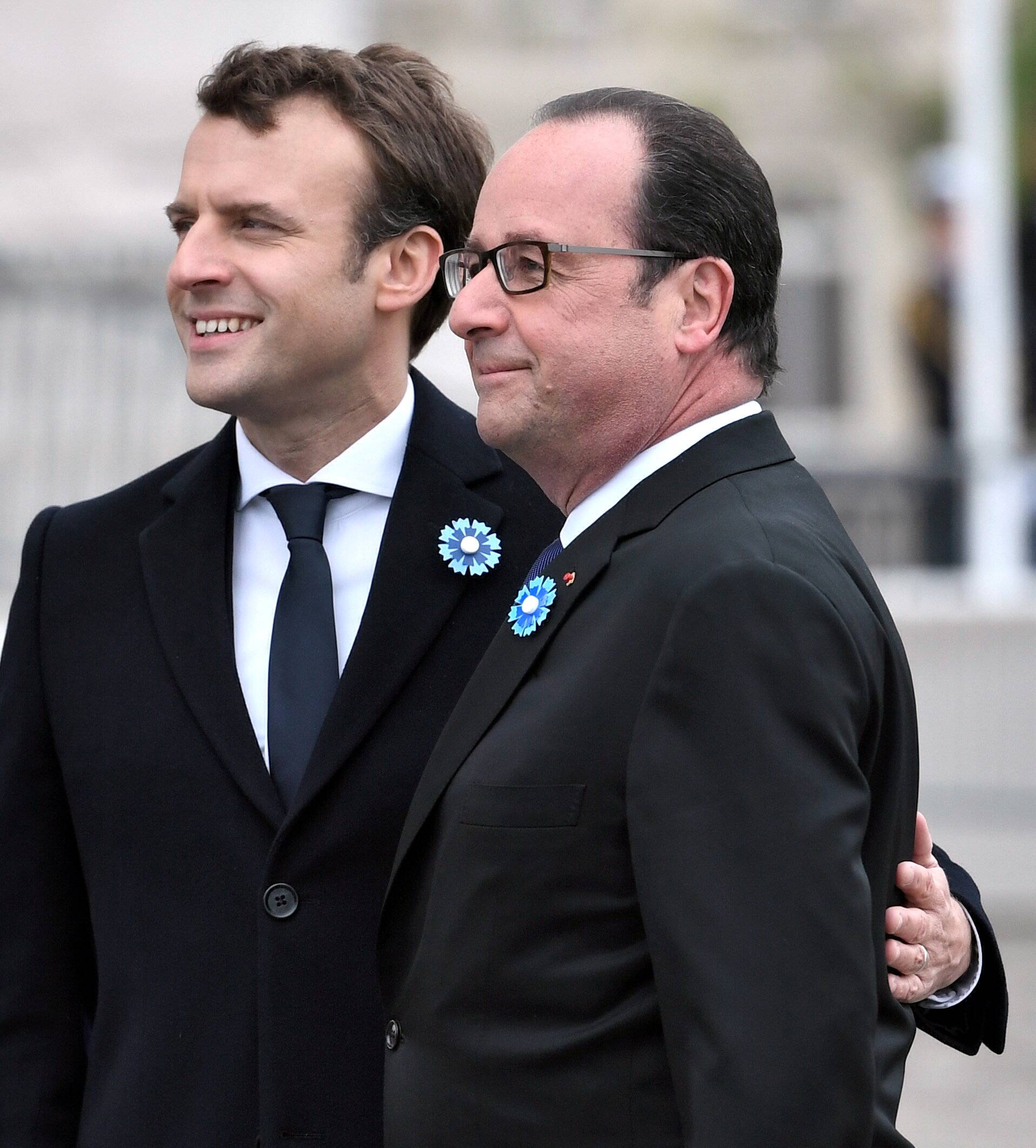 Outgoing French President Hollande and President-elect Macron attend a ceremony to mark the end of World War II at the Tomb of the Unknown Soldier at the Arc de Triomphe in Paris