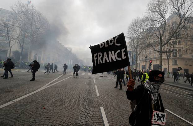 A protester holds a flag during a demonstration by the "yellow vests" movement in Paris