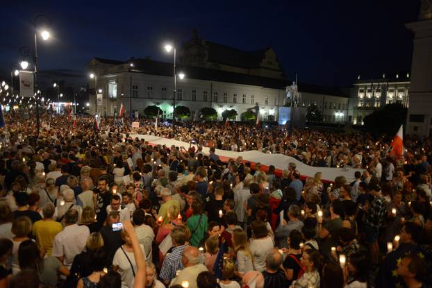 People gather during the "Chain of lights" protest against judicial overhaul in Warsaw