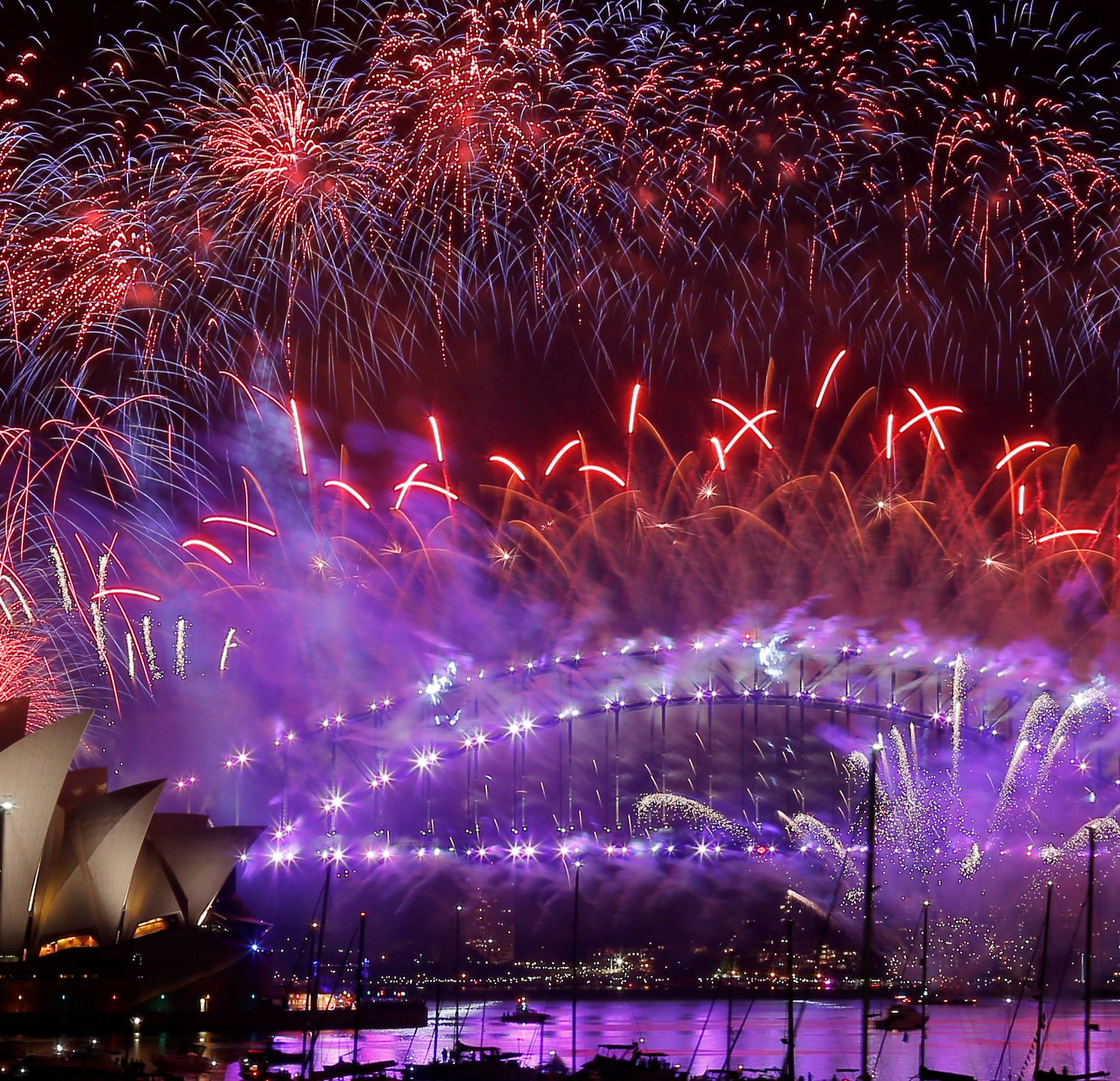 Fireworks explode over the Sydney Opera House and Harbour Bridge as Australia ushers in the New Year in Sydney