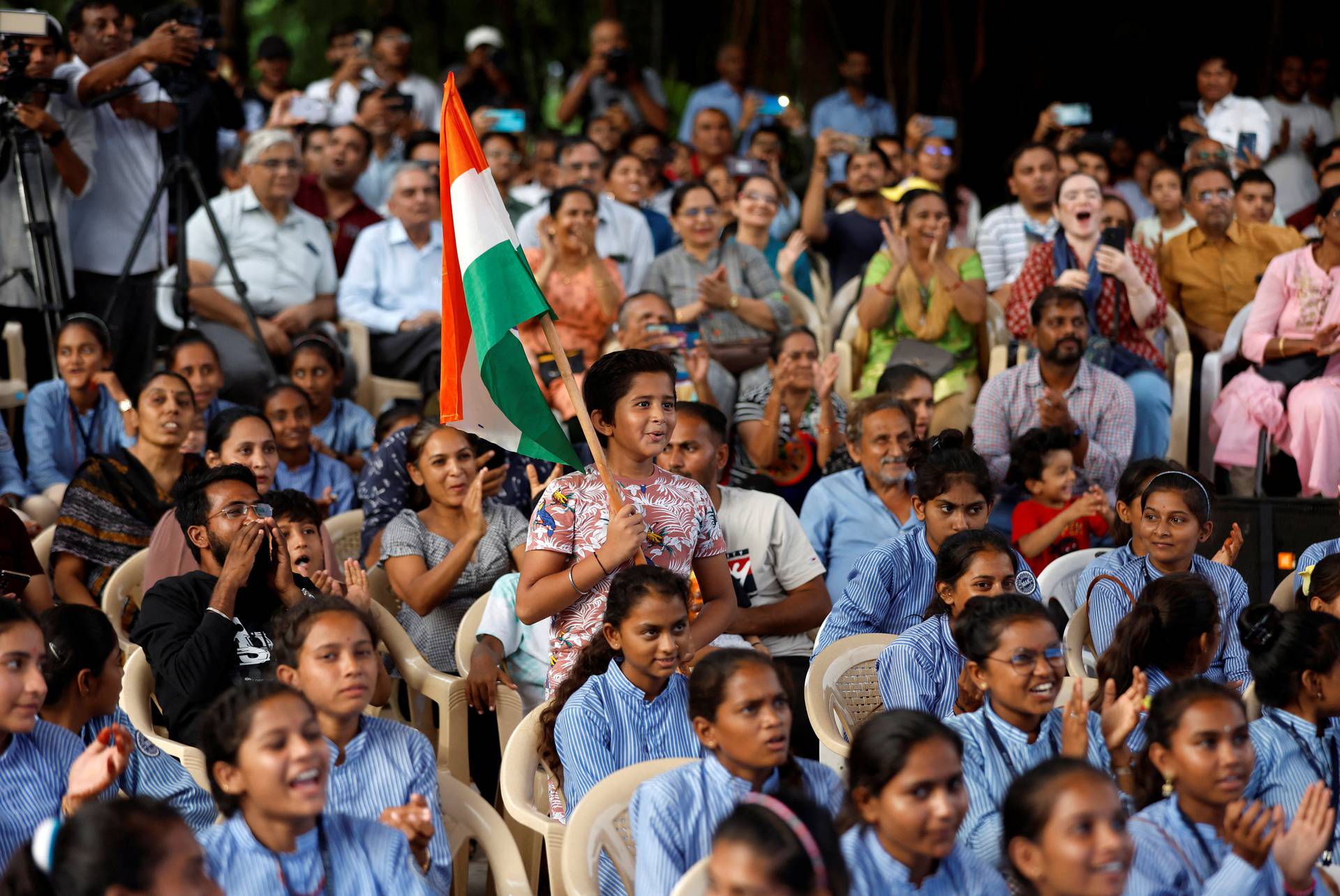 People react as they watch a live stream of Chandrayaan-3 spacecraft's landing on the moon, in Ahmedabad