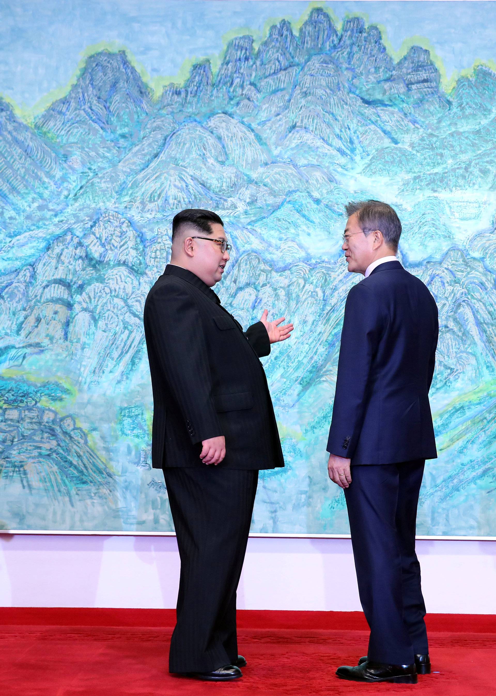 South Korean President Moon Jae-in talks with North Korean leader Kim Jong Un during their meeting at the Peace House