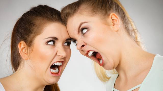 Two agressive women having argue fight