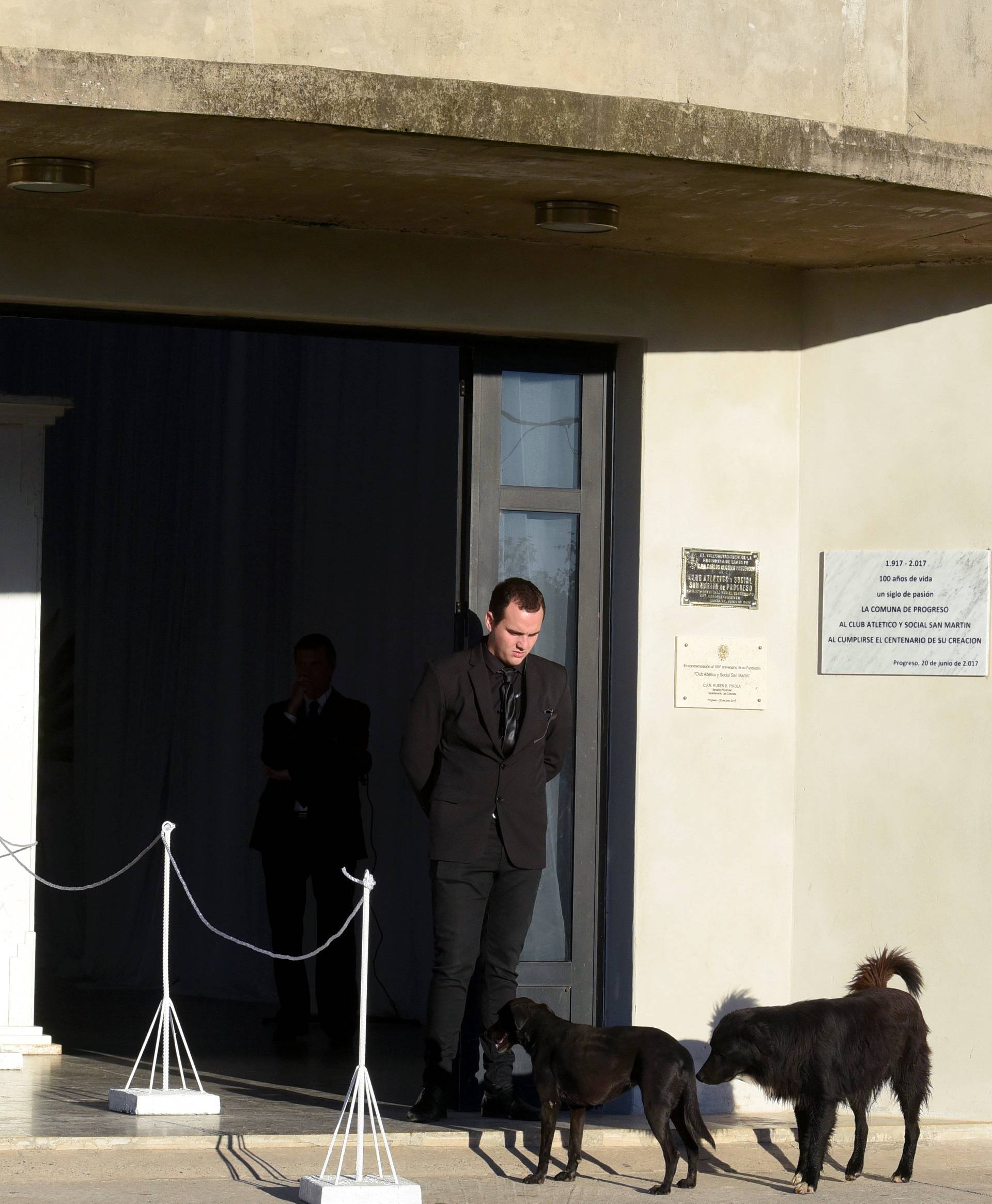 Dogs stand outside of the Emiliano Sala wake, who died in plane crash in the English Channel in Progreso