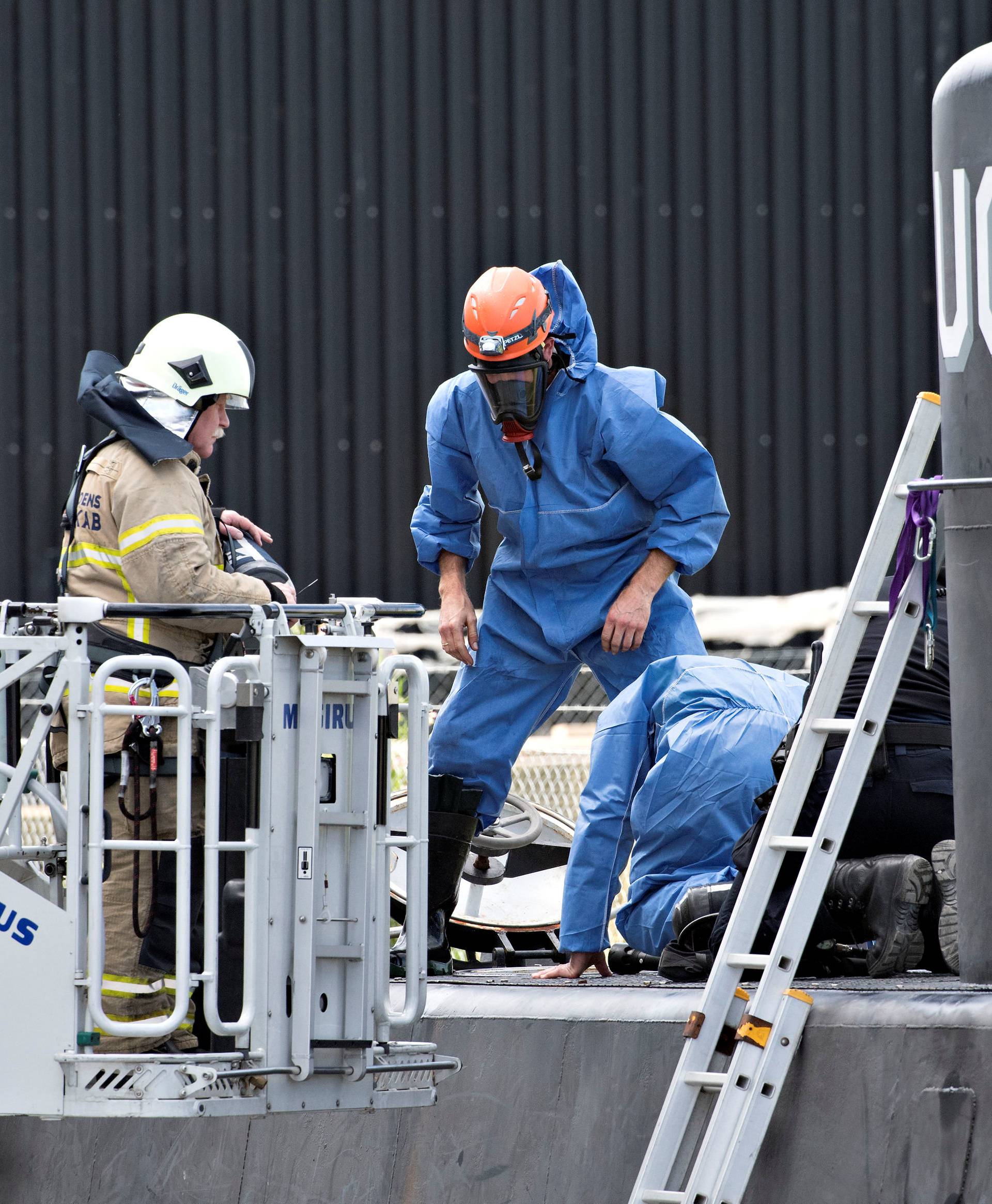 Police technicians investigate the rescued private submarine "UC3 Nautilus" in Copenhagen Harbor