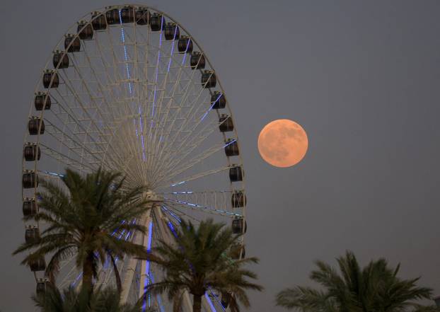 The "Blood Moon" rises in the sky during a total lunar eclipse,in Baghdad