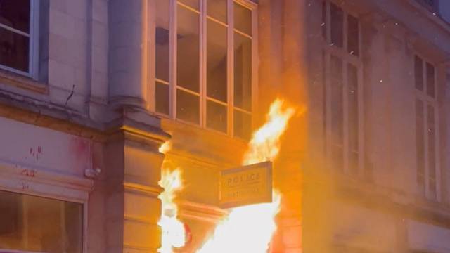 A police station entrance is seen on fire in Rennes
