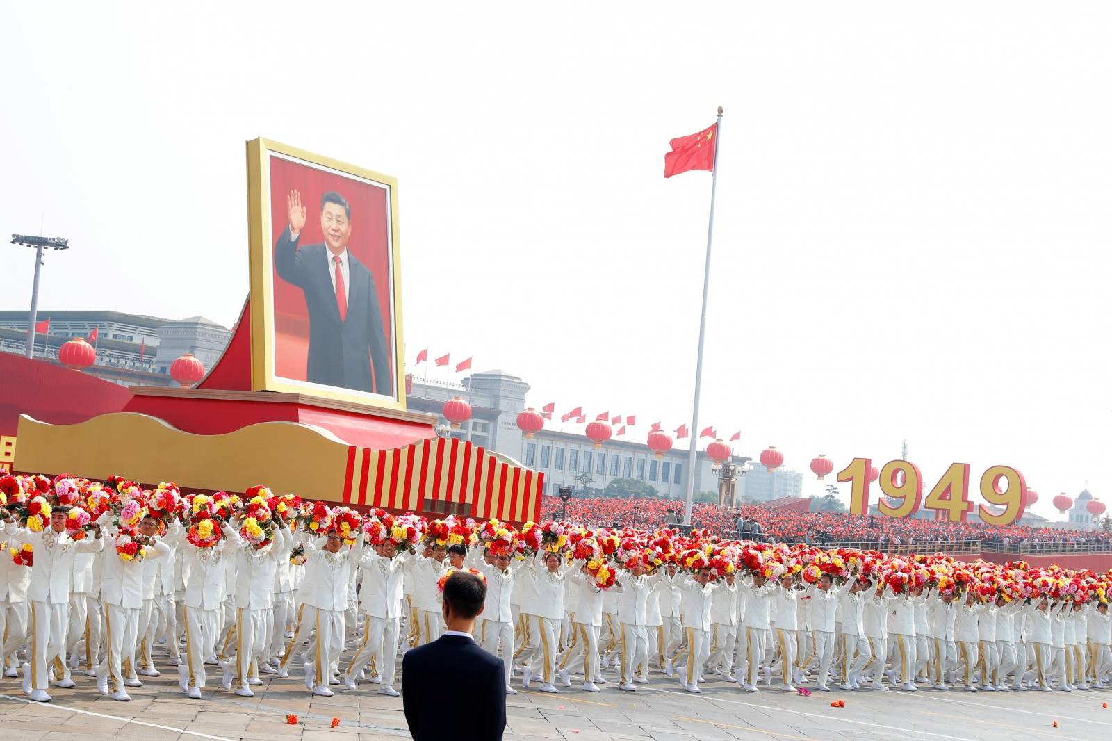 Performers travel past Tiananmen Square with a float showing Chinese President Xi during the parade marking the 70th founding anniversary of People's Republic of China