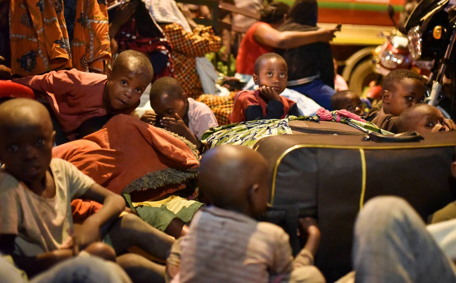 People gather with their belongings following a volcanic activities at Mount Nyiragongo near Goma