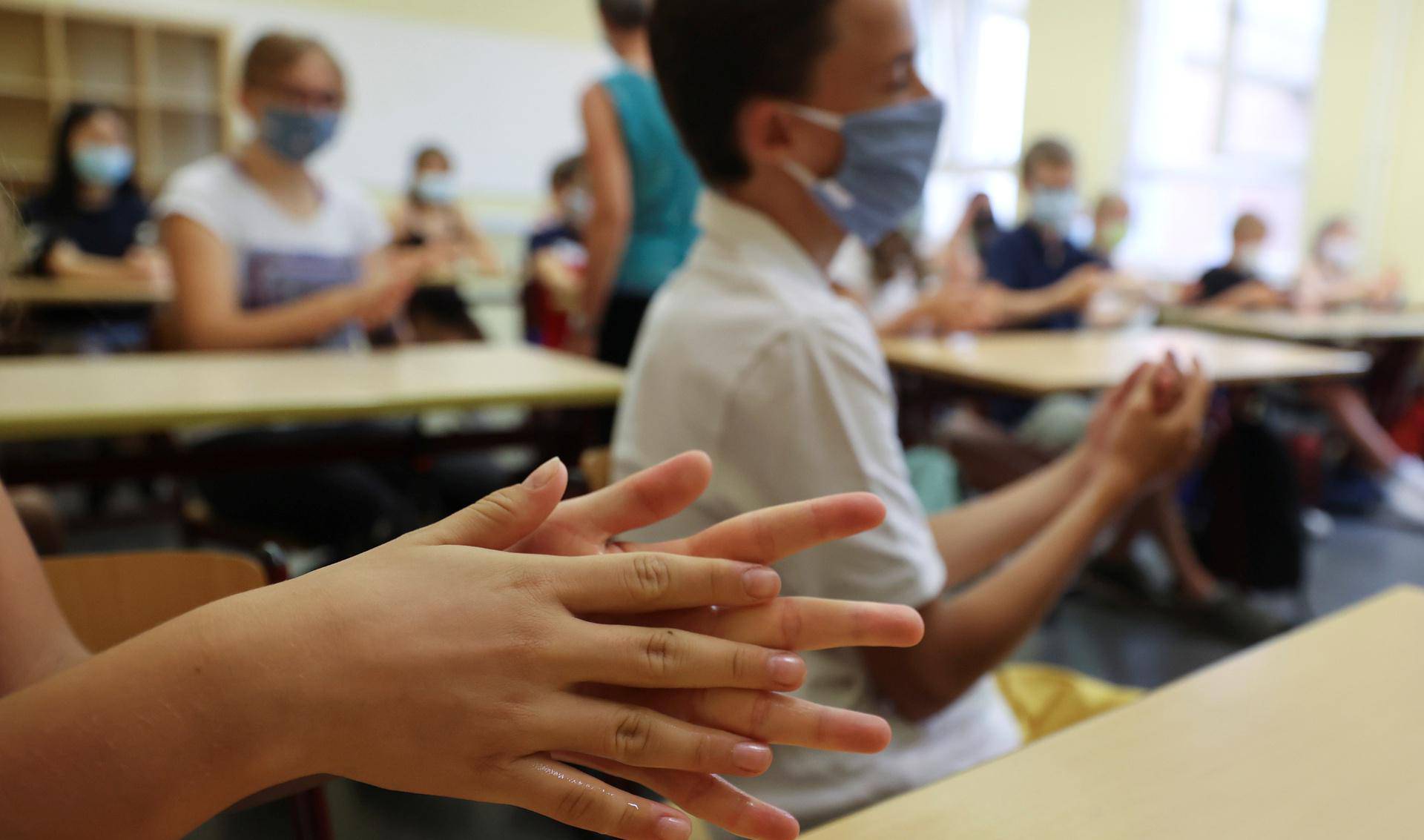 Pupils of the protestant high school "Zum Grauen Kloster" attend a lesson on the first day after the summer holidays in Berlin