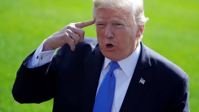 U.S. President Donald Trump talks with reporters as he departs the Oval Office of the White House for Dallas, in Washington D.C.