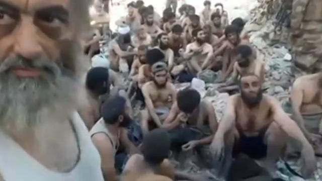 Still image taken from a video shows Islamic State militants surrender in the Old City of Mosul