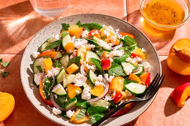 Peach,And,Cheese,Salad,With,Dressing,And,Herbs,On,Terracotta