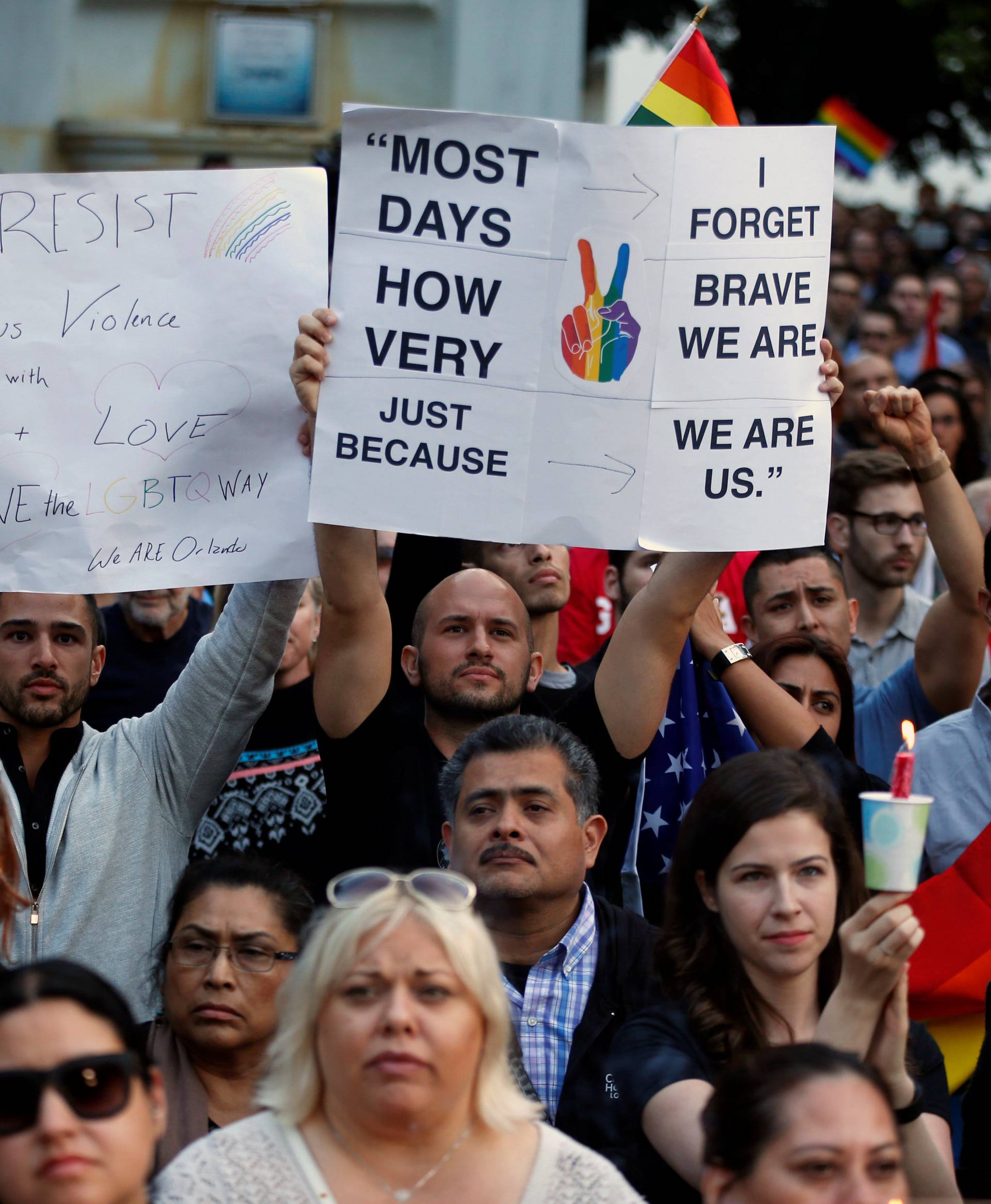 People attend a vigil in memory of victims one day after a mass shooting at the Pulse gay night club in Orlando, in Los Angeles