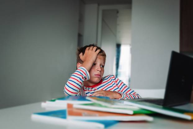 Bored,And,Sad,Kid,Looking,At,Computer,,Problems,With,Online