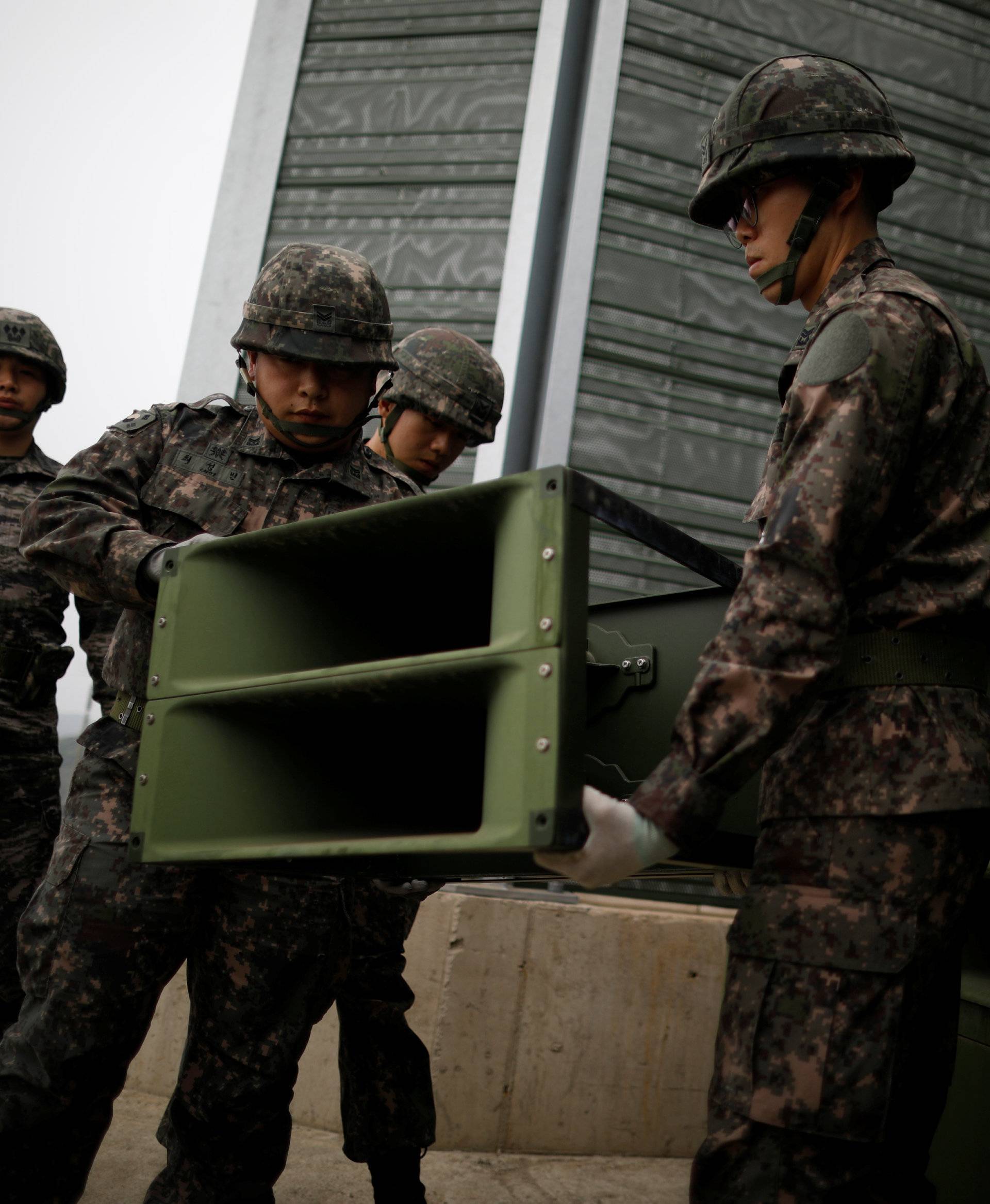 South Korean soldiers dismantle loudspeakers that were set up for propaganda broadcasts near the demilitarized zone separating the two Koreas in Paju