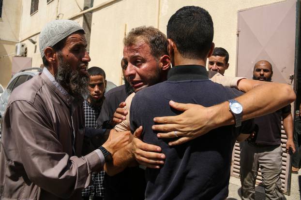 A Palestinian Mourns During Funeral of His Children - Deir al-Balah