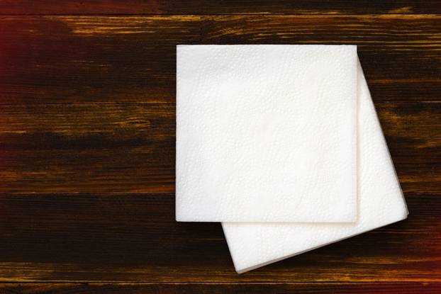 Napkin on wooden background.