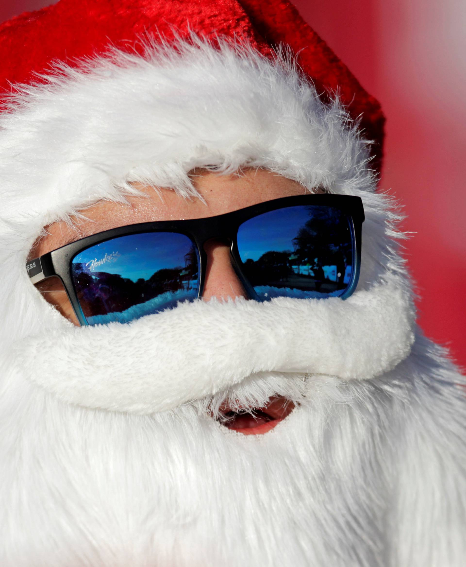 A man dressed as Santa Claus takes part in the annual race known as "Run Santa Run" at Fundidora Park in Monterrey