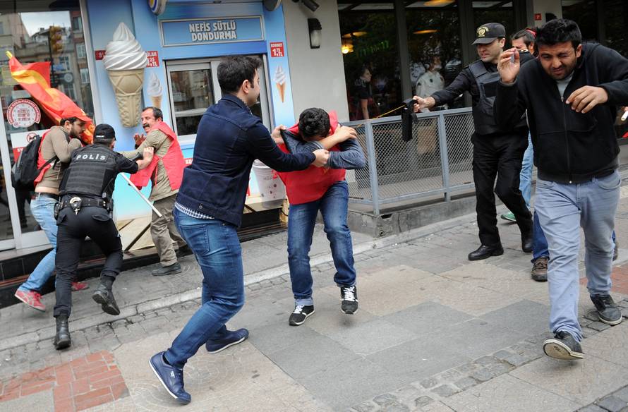 Turkish riot police use pepper spray while detaining a group of protesters who were attempting to defy a ban and march on Taksim Square to celebrate May Day, in Besiktas neighbourhood of Istanbul