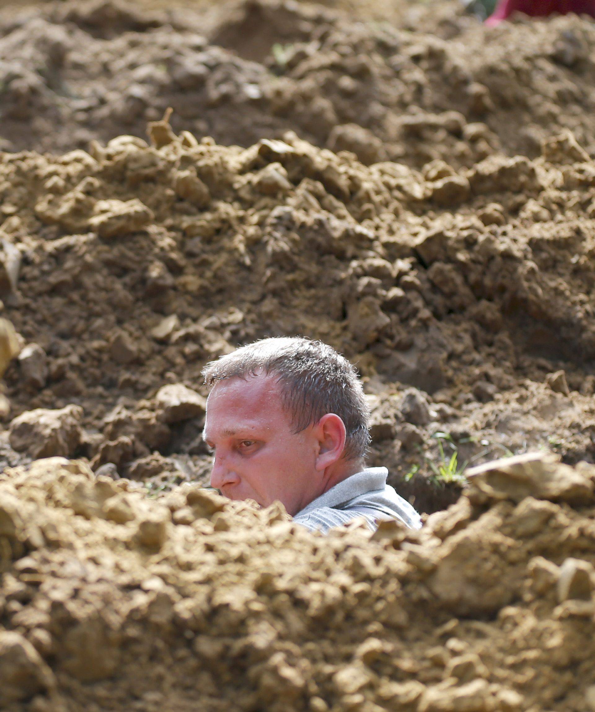 Gravedigger competes in Hungarian grave digging championship in Debrecen
