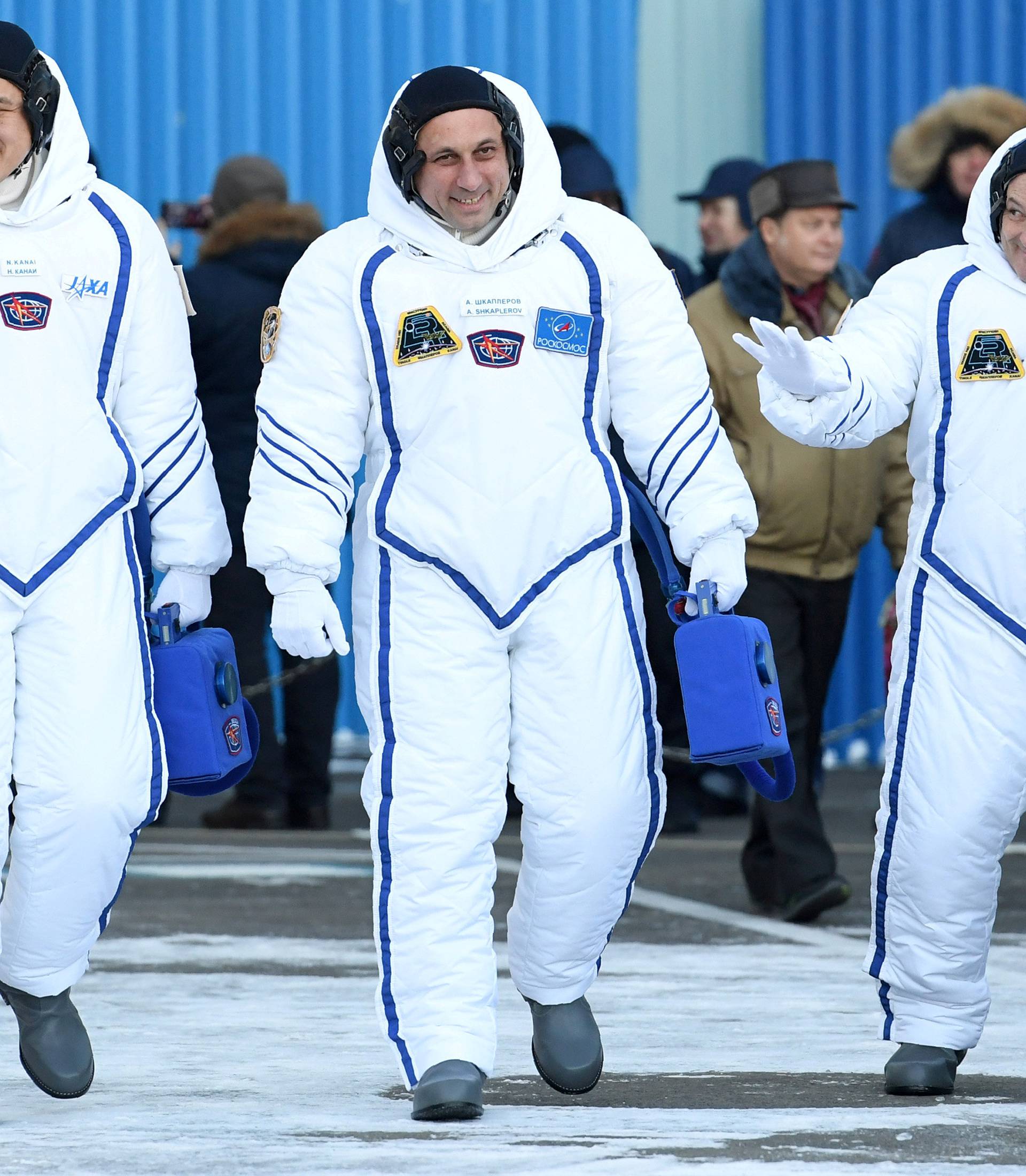 Members of the International Space Station expedition 54/55 during the send-off ceremony after checking their space suits before the launch of the Soyuz MS-07 spacecraft at the Baikonur cosmodrome