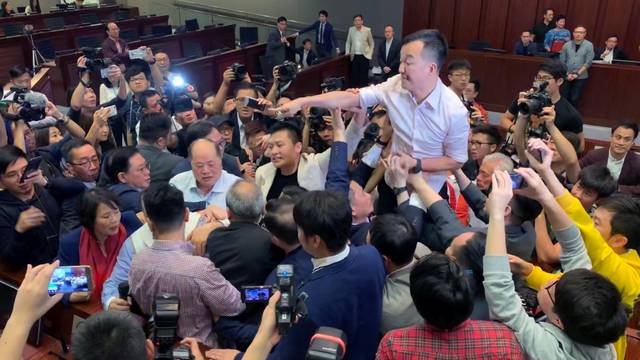 Pro-democracy lawmakers clash with pro-Beijing lawmakers during a meeting for control of a meeting room to consider the controversial extradition bill, in Hong Kong