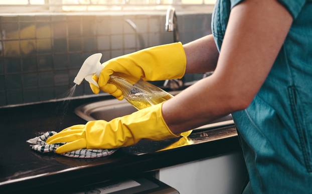 Goodbye germs and bacteria. Cropped shot of an unrecognizable woman using cleaning detergent to clean her kitchen at home.