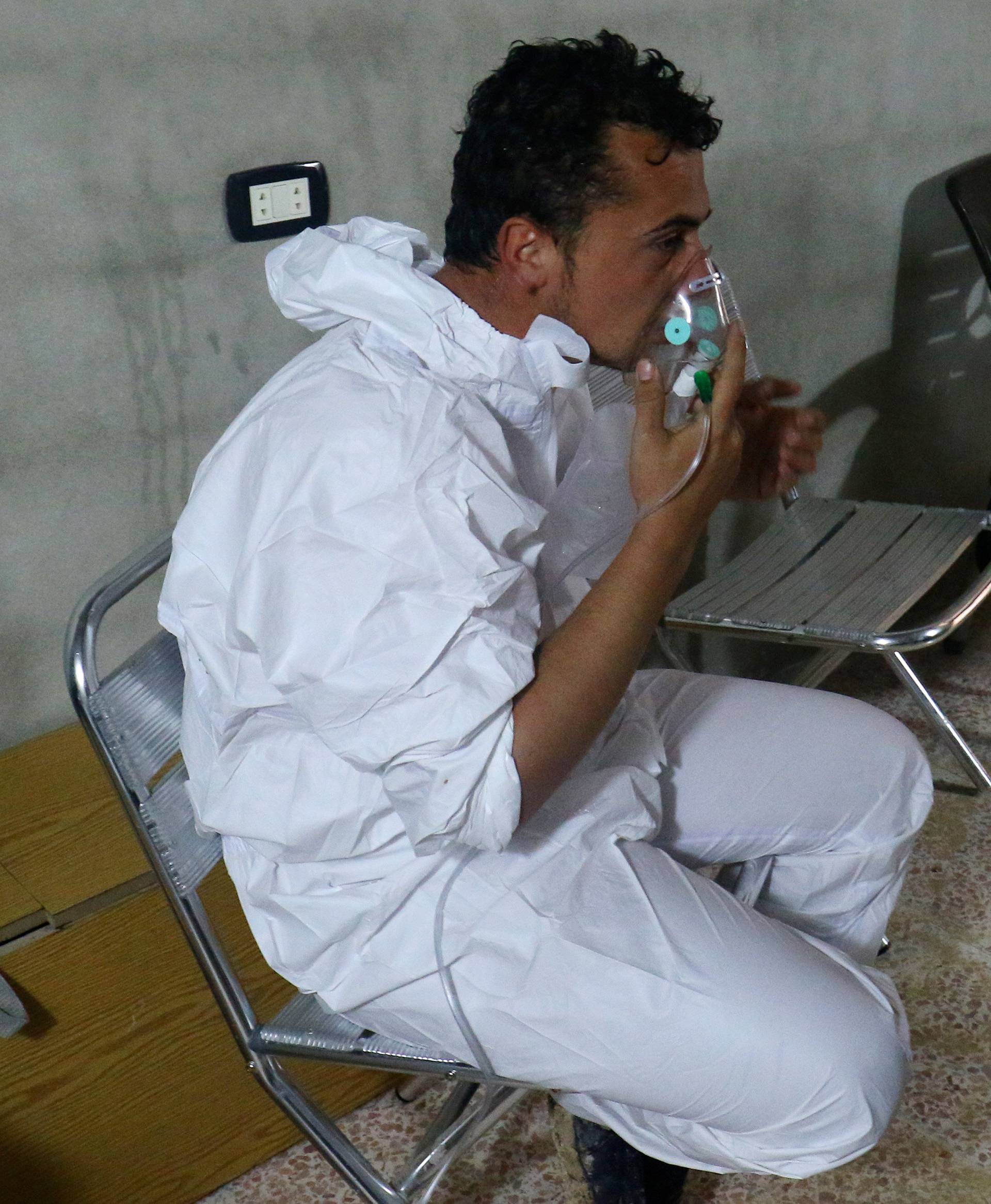 A man breathes through an oxygen mask, after what rescue workers described as a suspected gas attack in the town of Khan Sheikhoun in rebel-held Idlib