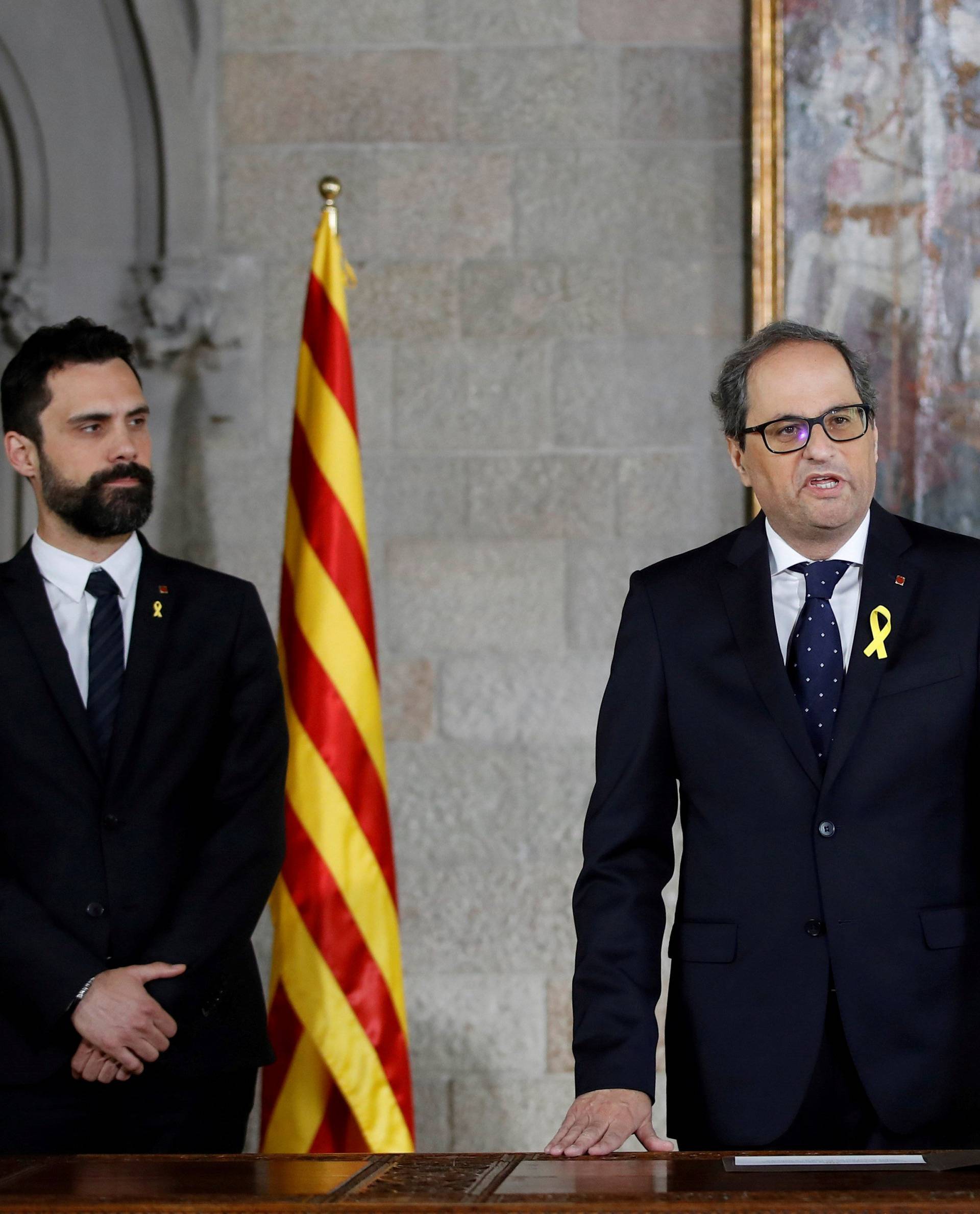 Quim Torra takes his oath as new Catalan Regional President next to regional parliament speaker Roger Torrent during a ceremony at Generalitat Palace in Barcelona