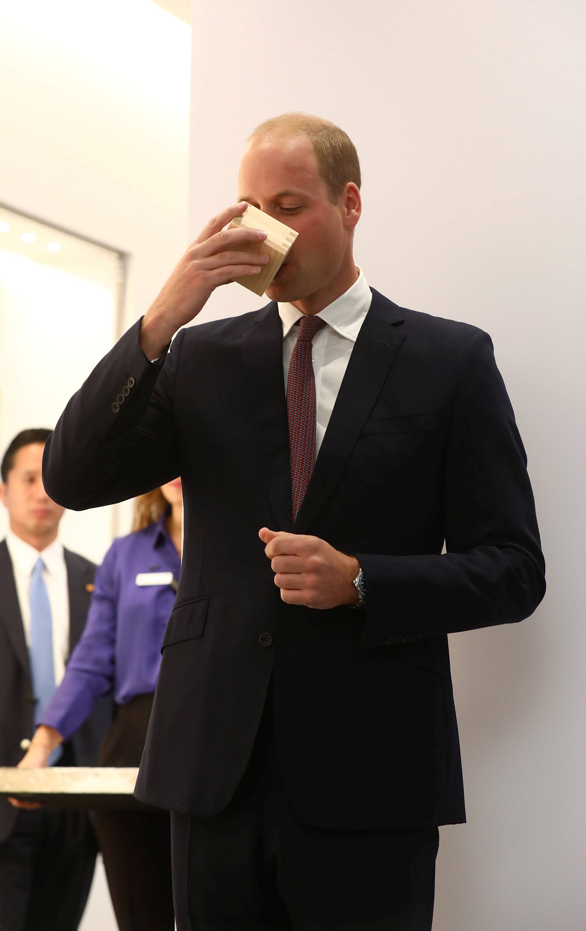 Britain's Prince William takes a sip of sake at the official opening of Japan House in London