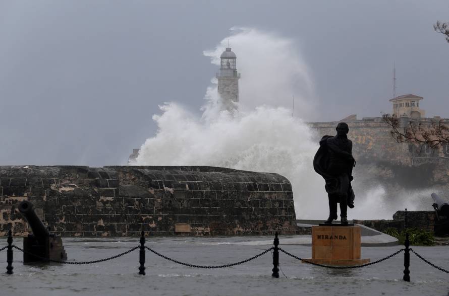 Waves crash against the lighthouse after the passing of Hurricane Irma, in Havana