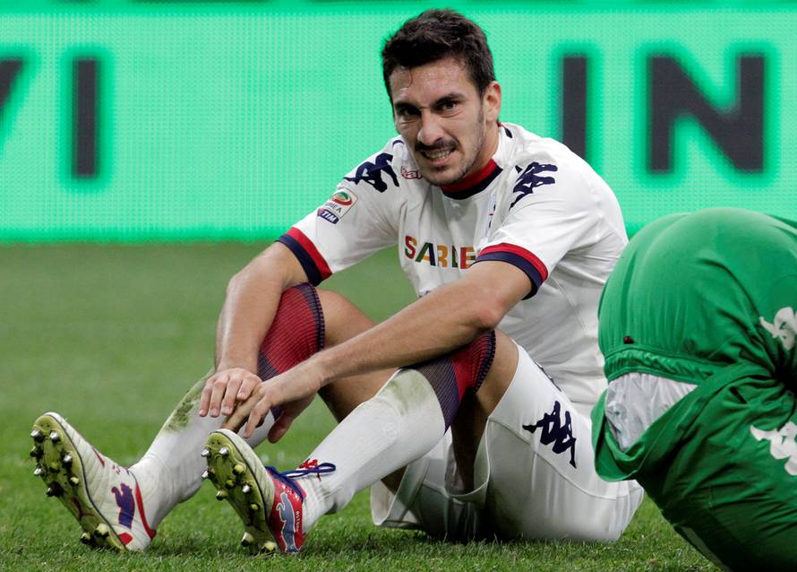 FILE PHOTO: Cagliari's Astori reacts after scoring an own goal against Inter Milan during their Italian Serie A soccer match in Milan