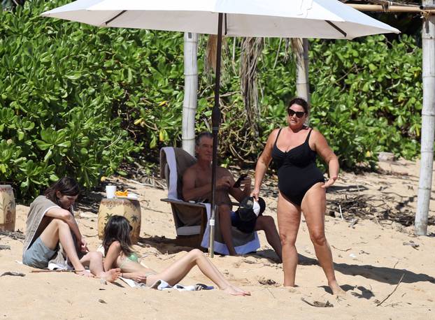 EXCLUSIVE: *NO WEB UNTIL 1530 EST 22ND MAR* Pierce Brosnan hits the beach in Hawaii with his wife Keely Shaye Smith and son Dylan, The former 007 star took a dip in the ocean before relaxing with the family under a umbrella on the beach.