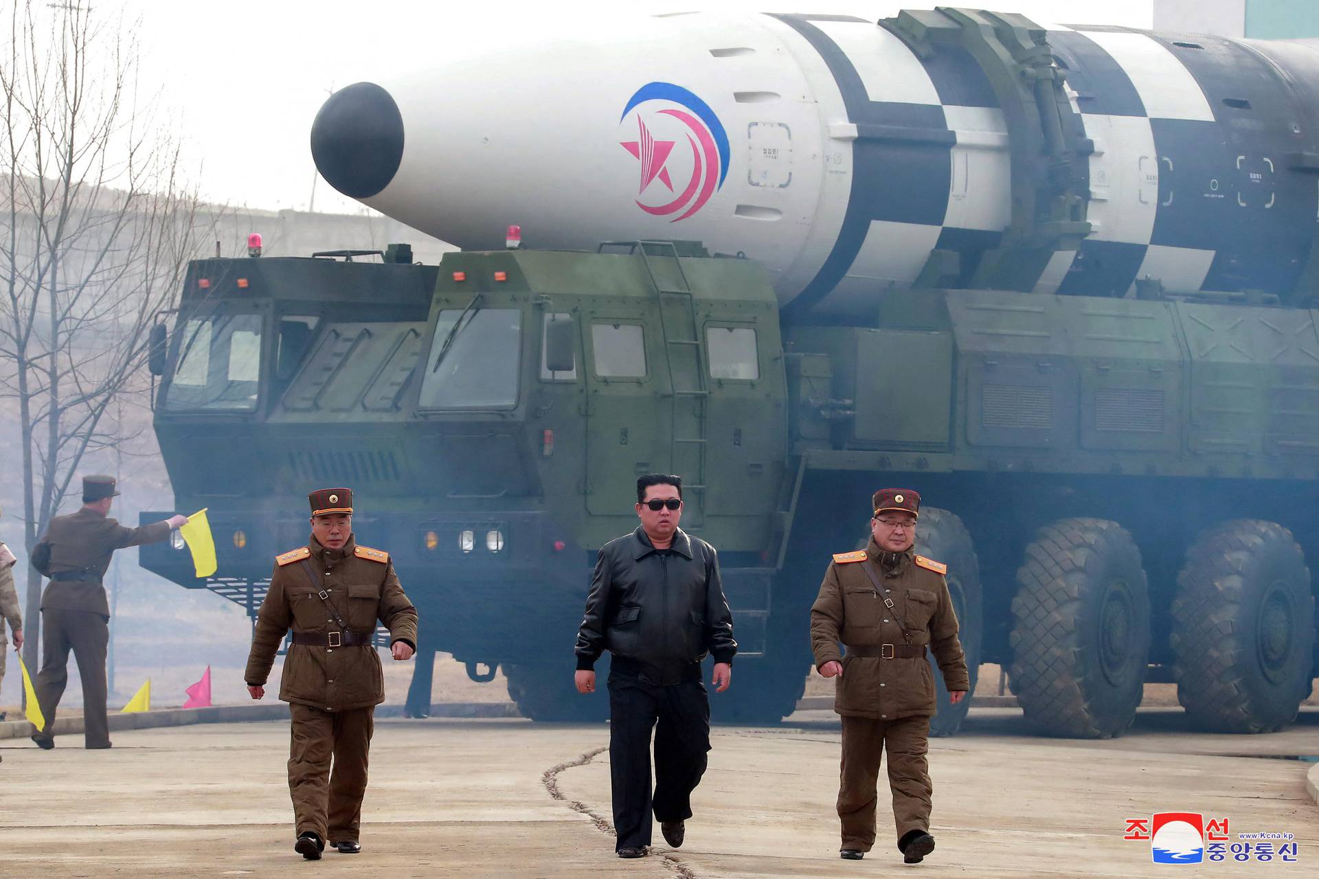 North Korean leader Kim Jong Un walks away from a missile