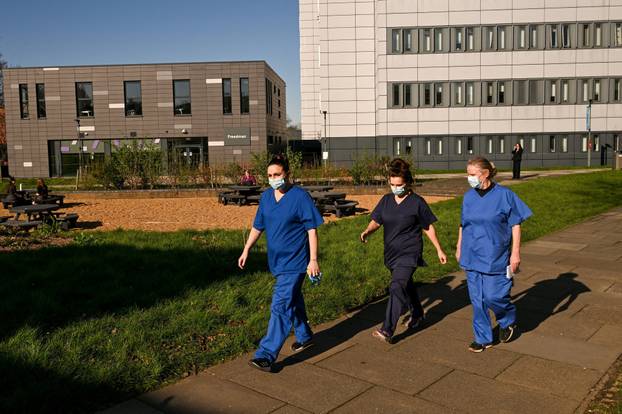 FILE PHOTO: People queue to receive vaccinations at the Sports centre on the University of Kent campus, following an outbreak of meningitis cases in Kent
