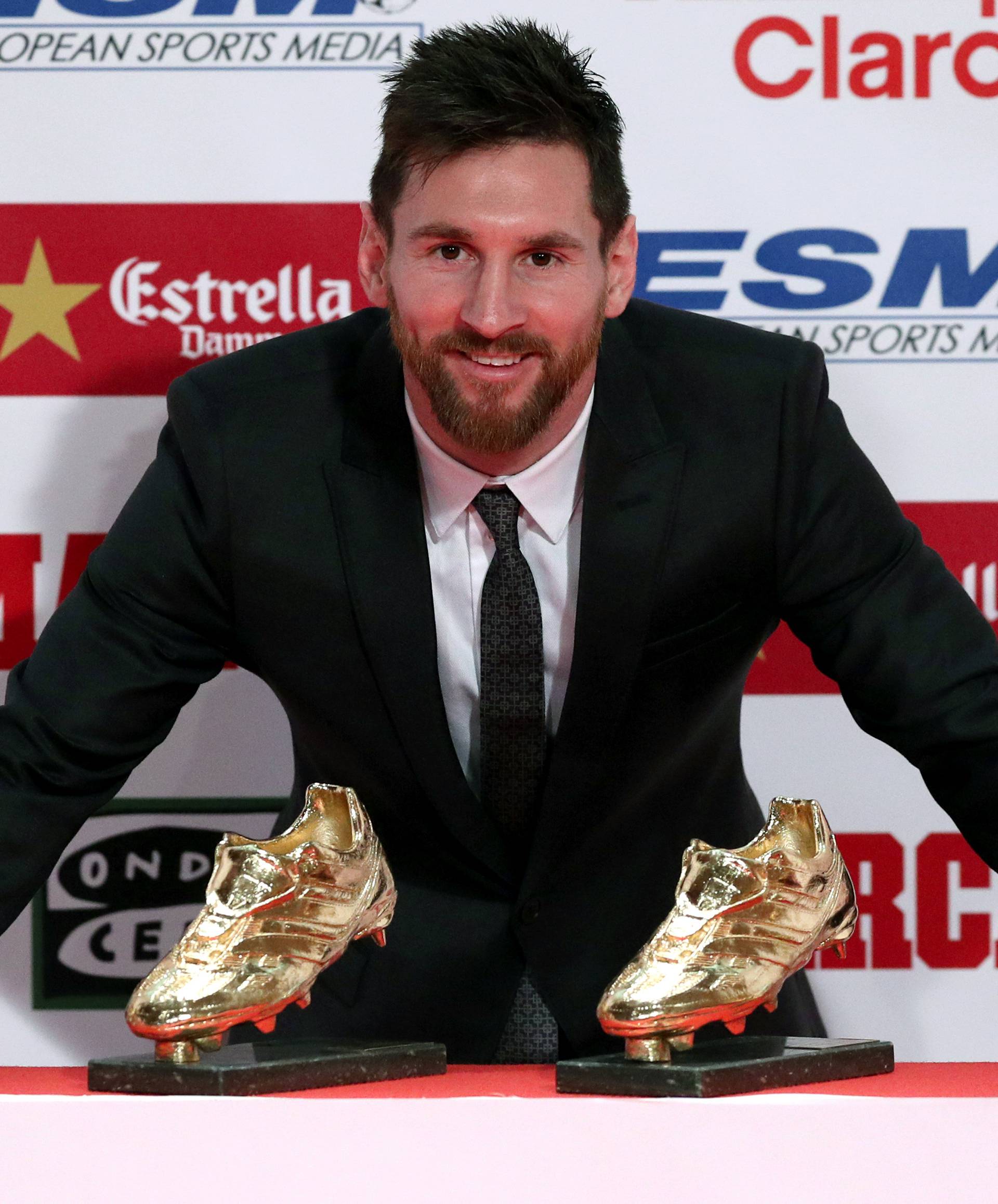 Barcelona's Lionel Messi poses with his four Golden Boot trophies during a ceremony in Barcelona